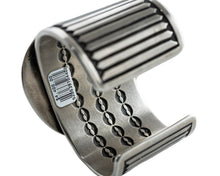 Load image into Gallery viewer, Inside view of a Navajo silver bracelet with intricate stamp work designed inside the bracelet

