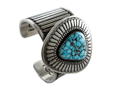Navajo silver cuff bracelet with Kingman turquoise stone on a white background