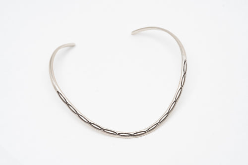 Silver thin Native American contemporary chocker necklace on a white background