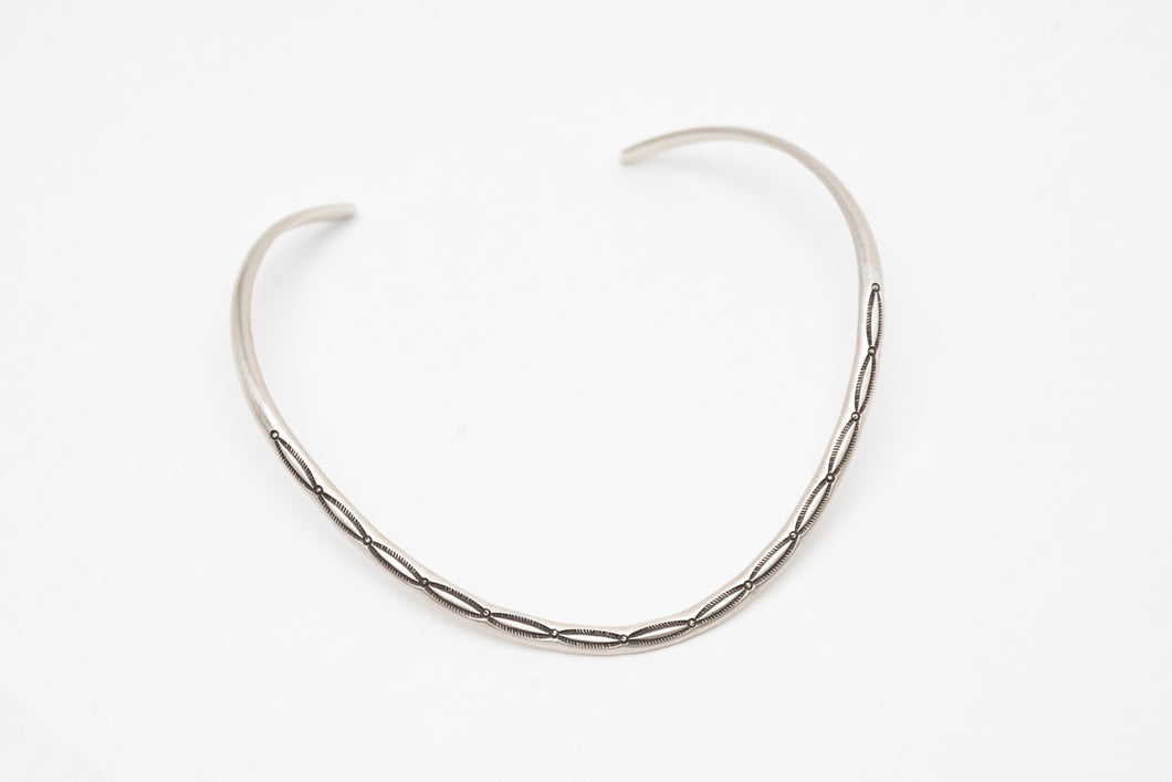Silver thin Native American contemporary chocker necklace on a white background