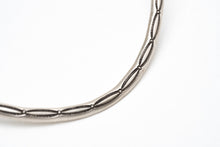 Load image into Gallery viewer, Silver necklace on a white background
