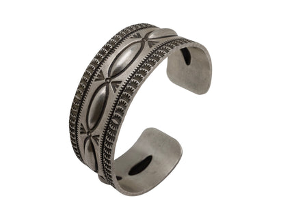 Artisan sterling silver cuff bracelet with raised repousse ovals and hand-stamped geometric detailing in a heritage Southwestern style.
