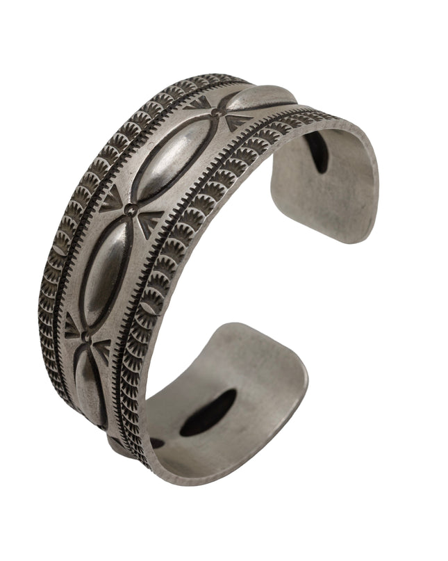 Artisan sterling silver cuff bracelet with raised repousse ovals and hand-stamped geometric detailing in a heritage Southwestern style.