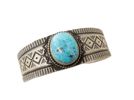 Silver bracelet with turquoise stone on a white background