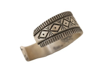 Load image into Gallery viewer, Silver ring with intricate stamped patterns on a light white background
