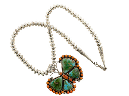 Butterfly necklace with a turquoise and coral pendant on a white background