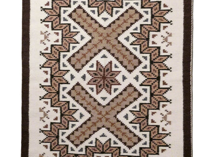 Woven navajo rug with geometric pattern on a plain background