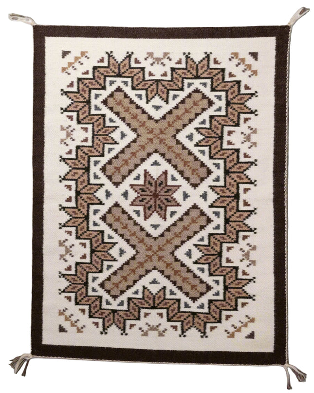 Woven navajo rug with geometric pattern on a plain background