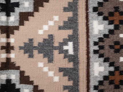 Hand-woven Navajo Rug with geometric pattern on a plain white background, side center view