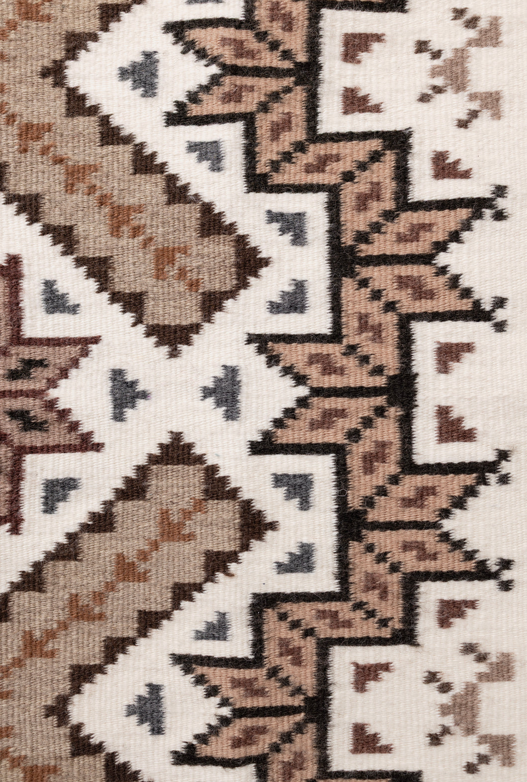 Side close-up of a navajo patterned rug with geometric design