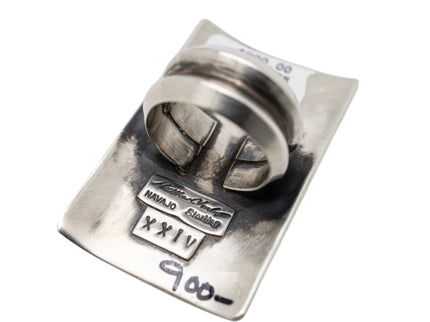 Silver ring with engraved details on a white background