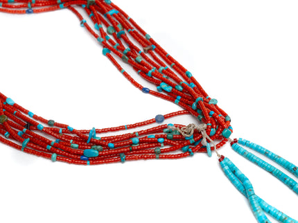 Single Native American necklace with nine strands of Mediterranean coral with sleeping beauty, Royston and Kingman Turquoise stones, and Lapis on a white background