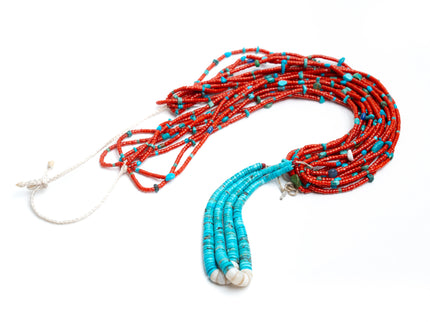 Single Native American necklace with nine strands of Mediterranean coral with sleeping beauty, Royston and Kingman Turquoise stones, and Lapis on a white background