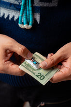 Load image into Gallery viewer, Close-up of hands holding a twenty-dollar bill with a Native American silver money clip
