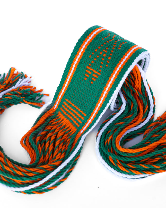 Green and orange Navajo Sash Belt Rolled Up with Fringe Hanging out