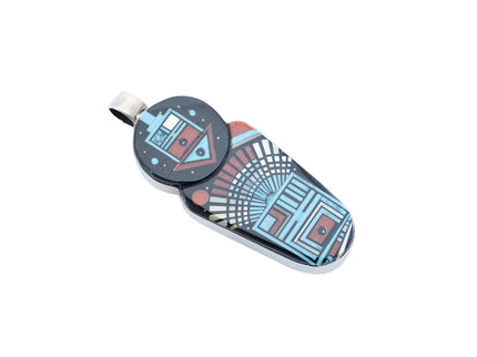 Colorful inlay Navajo pendant with deity images on a white background