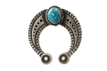 Load image into Gallery viewer, Silver u-shaped jewelry piece with a turquoise stone and stamp work on a light gray background
