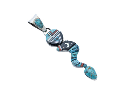 Pendant shaped like a snake made with turquoise, jet black stone, and sterling silver with a moon in the middle and a circular head with the design of a Navajo deity on a white background
