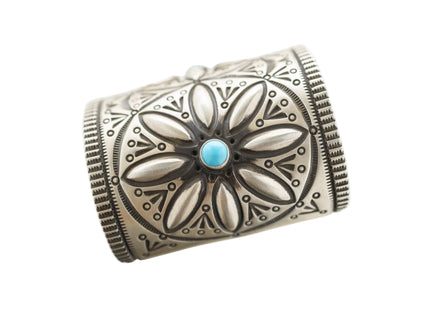 Close up of Herman Smith sterling silver cuff with three Beauty turquoise gemstones and hand-stamped patterns 