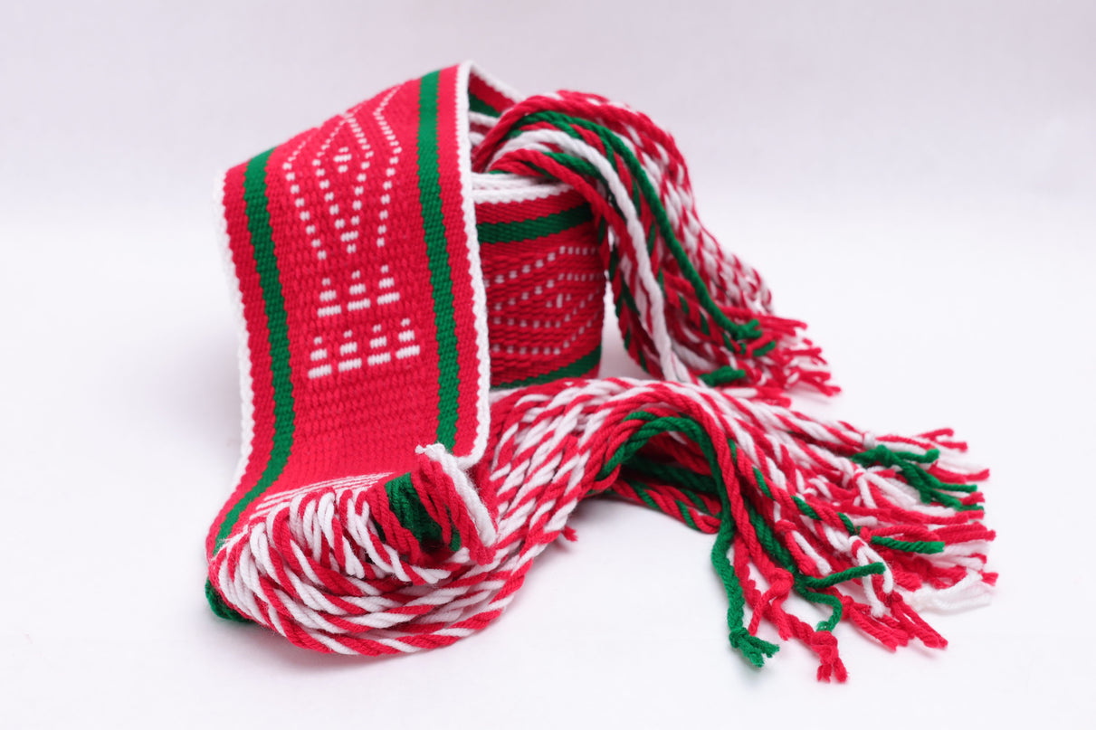 Red and white traditional sash with two green lines rolled up on a white background