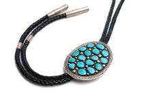 Load image into Gallery viewer, Bolo tie 17 turquoise stones with a black leather strap on a white background
