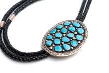 Load image into Gallery viewer, Bolo tie with 17 turquoise stones and black cord on a white background
