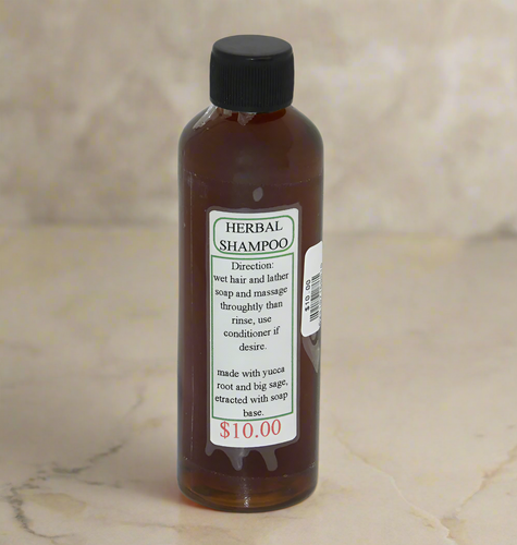Small clear bottle filled with Navajo herbal shampoo with a simple label