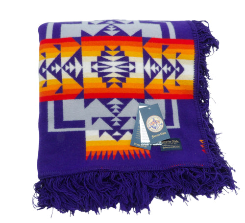 Pendleton Chief Joseph Blanket in purple featuring a traditional Native American-inspired geometric pattern with arrow motifs, folded neatly to show intricate design and soft wool texture. front View 