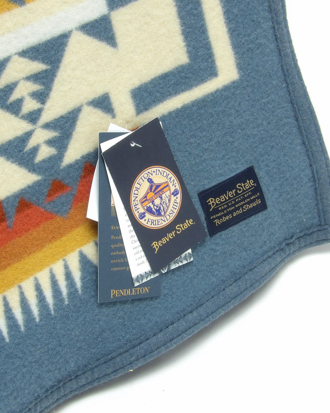 Pendleton Chief Joseph Blanket in Shale featuring a traditional Native American-inspired geometric pattern with arrow motifs, folded neatly to show intricate design and soft wool texture., tag view