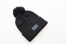 Load image into Gallery viewer, Flat view of a Pendleton classic black beanie with pom-pom and logo on a white background
