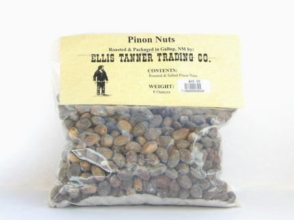 A clear plastic package containing 8 ounces of roasted piñon nuts, with a label displaying the brand name, product name, and weight.