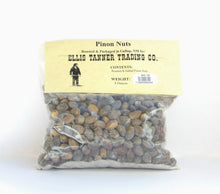 Load image into Gallery viewer, A clear plastic package containing 8 ounces of roasted piñon nuts, with a label displaying the brand name, product name, and weight.
