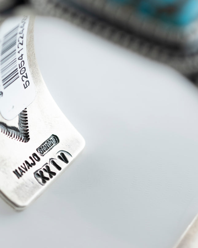 Inside view of year mark and "sterling" mark with a small stamp "Navajo", placed on a white background 