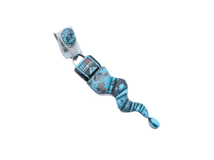 Turquoise and silver pendant shaped like a snake with a Navajo deity head on a white background