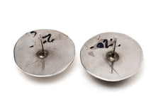 Load image into Gallery viewer, Back of a pair of studded silver earrings on a white background

