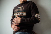 Load image into Gallery viewer, Navajo male wearing a dark brown sweater with Chief Joseph pattern, standing against a plain background
