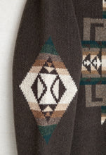 Load image into Gallery viewer, Closeup of Chief Joseph pattern on a brown pullover sweater sleeve
