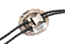 Load image into Gallery viewer, Close-up of the back of a silver bolo tie with a metal clasp and black braided cord on a white background
