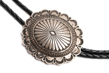 Load image into Gallery viewer, Close-up of a Navajo silver bolo tie with intricate stamp design on a white background
