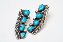 Load image into Gallery viewer, Pair of Native American old-fashioned silver stamped earrings with turquoise stones on a white background
