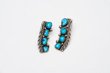 Load image into Gallery viewer, Pair of Native American silver stamped earrings with turquoise stones on a white background
