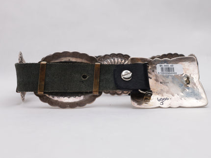 Silver belt buckle with black strap on a white background