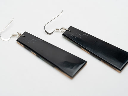 Black rectangular Zuni Native American earrings on a white background