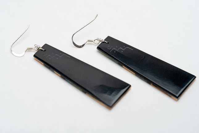 Black rectangular Zuni Native American earrings on a white background