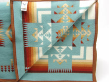 Load image into Gallery viewer, Pendleton Chief Joseph Blanket in aqua, featuring a traditional Native American-inspired geometric pattern with arrow motifs, folded neatly to show intricate design and soft wool texture
