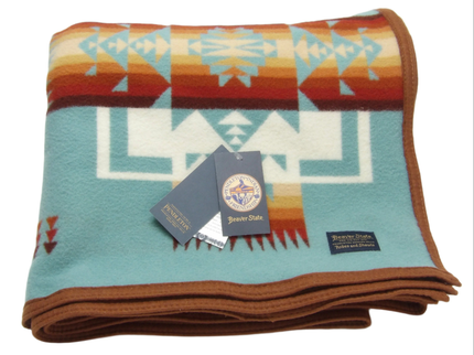 Pendleton Chief Joseph Blanket in aqua, featuring a traditional Native American-inspired geometric pattern with arrow motifs, folded neatly to show intricate design and soft wool texture. front View 