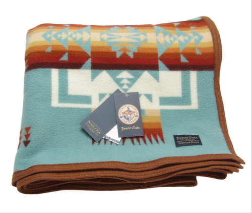 Pendleton Chief Joseph Blanket in aqua, featuring a traditional Native American-inspired geometric pattern with arrow motifs, folded neatly to show intricate design and soft wool texture. front View 