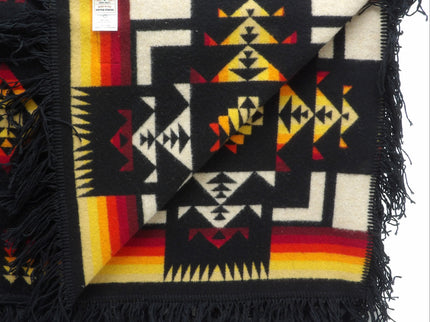 Pendleton Chief Joseph Blanket in Black featuring a traditional Native American-inspired geometric pattern with arrow motifs, folded neatly to show intricate design and soft wool texture. Inside View