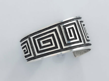 Navajo Cuff bracelet with square geometric pattern on a light gray background