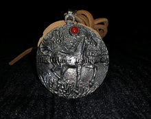 Load image into Gallery viewer, A circle silver pendant with a sand cast horse and one coral stone, with a tan leather strap. Displayed on top of a black cloth  front
